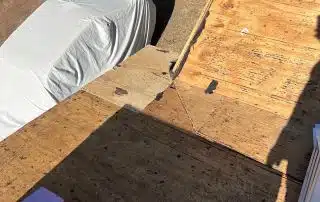 Rooftop construction area with visible tarpaper.