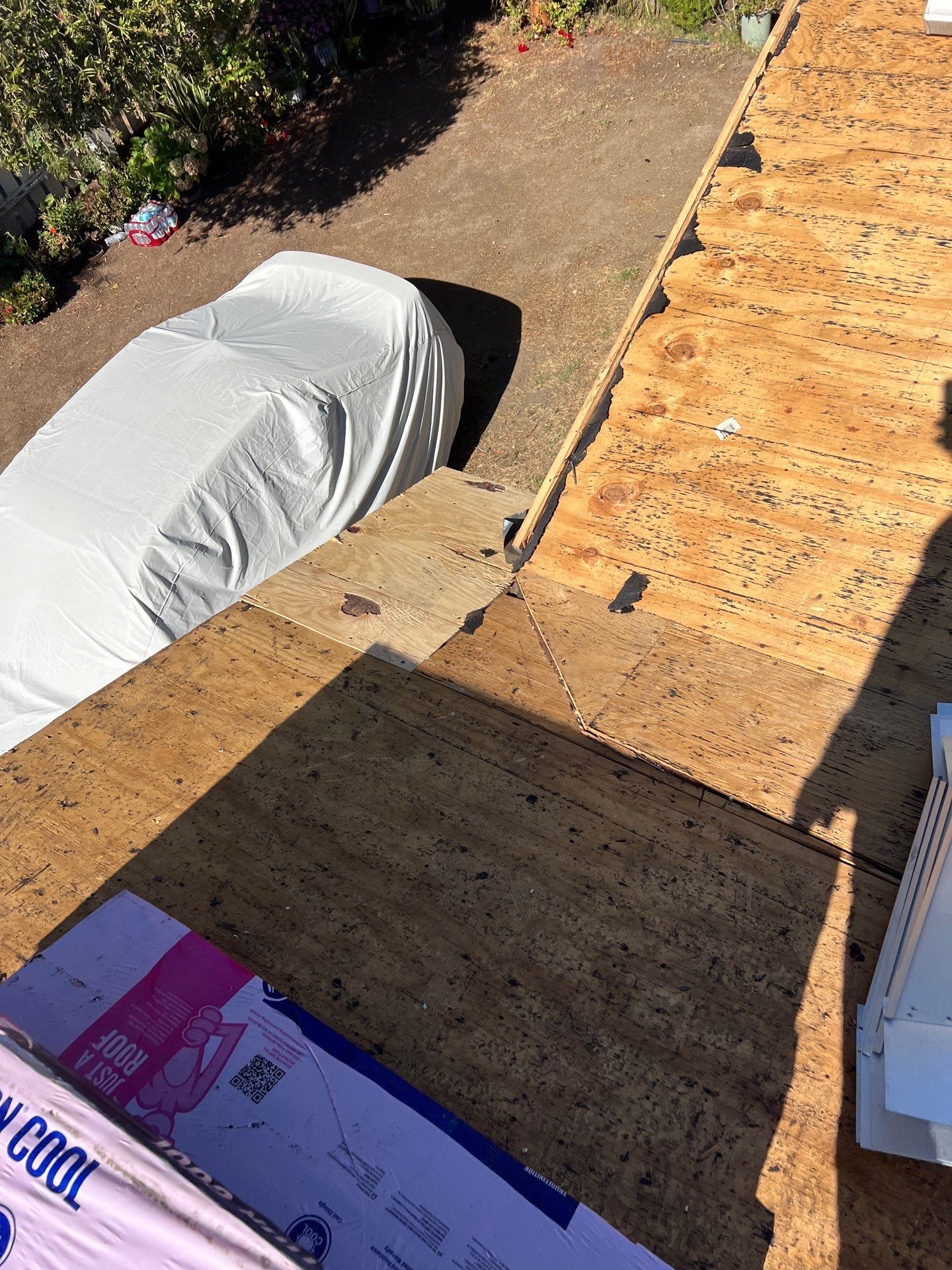 Rooftop construction area with visible tarpaper.