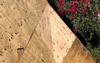 Wooden boards with red flowers in background