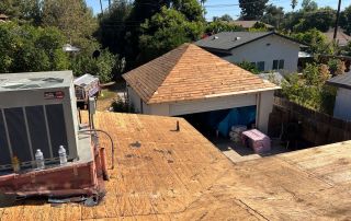 Rooftop view of a backyard and garage.