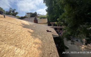 New roof construction with wooden boards and tools.