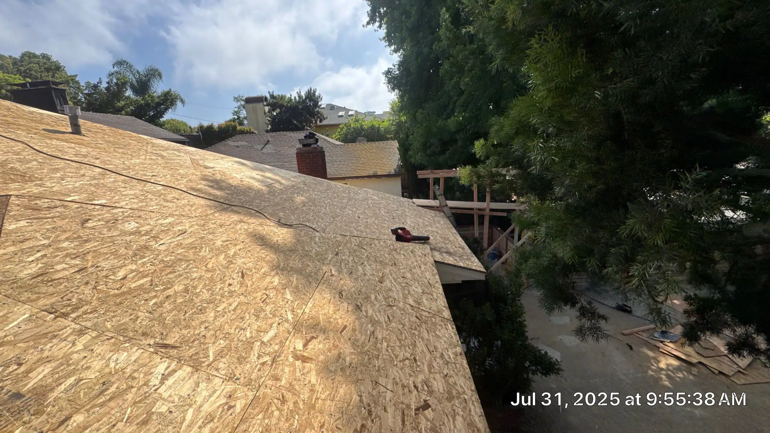 New roof construction with wooden boards and tools.