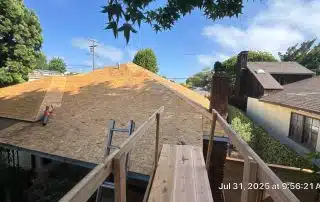 House roof under construction with ladder access.