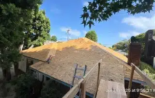 New plywood roof installation in a residential area.
