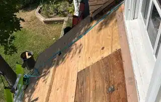 Rooftop under renovation with wooden planks.