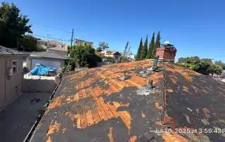 Damaged roof needing repair under clear sky
