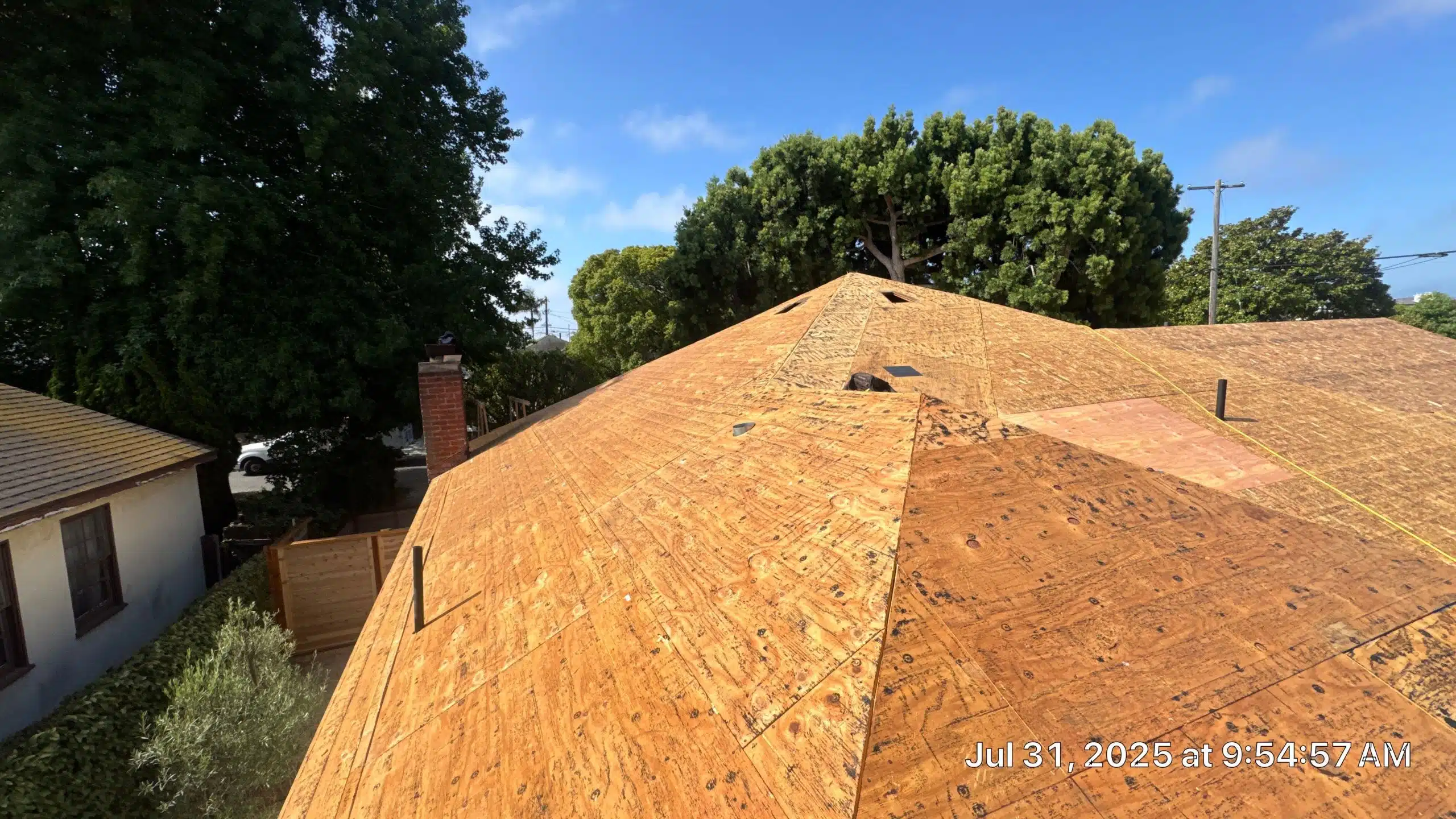 New plywood roof under construction, sunny day