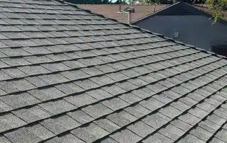 Shingle roof under clear blue sky.
