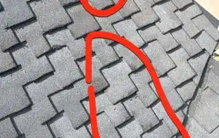 Roof shingle damage circled in red marker.