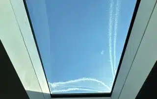Blue sky through a glass ceiling window.