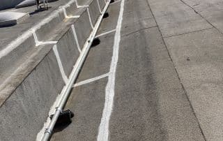 Rooftop with air conditioning units and pipes.