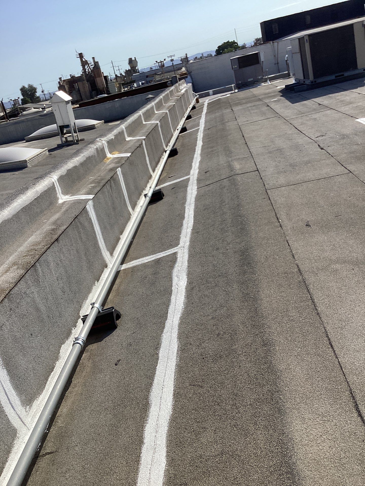 Rooftop with air conditioning units and pipes.