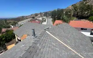 Roof view over suburban neighborhood, sunny day.