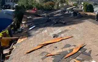 Roof repair work in progress on sunny day.