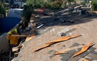 Roof repair work in progress on sunny day