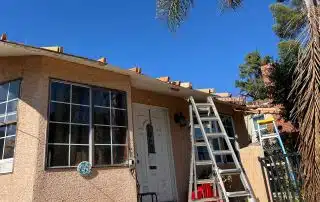 House roof under construction with ladders.