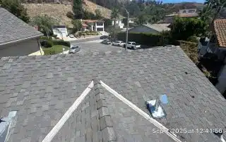 Suburban street view from rooftop, sunny day.