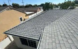 Gray shingle roof under clear sky.