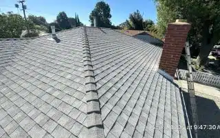 Asphalt shingle roof with chimney and ladder
