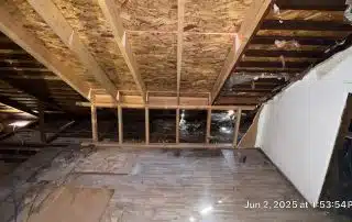 Attic space under construction with wooden beams.