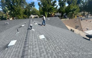 Roof inspection in progress on sunny day