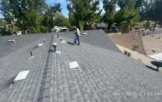 Roof inspection in progress on sunny day