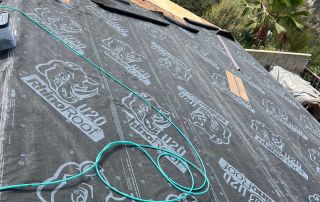 12-Sep 12 2025 10_46am-BgGc Roofing underlayment installation near brick chimney.