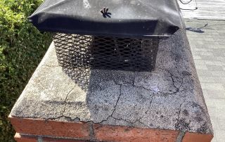Chimney cap with brick and moss-covered surface