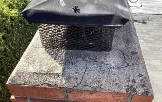Chimney cap with brick and moss-covered surface