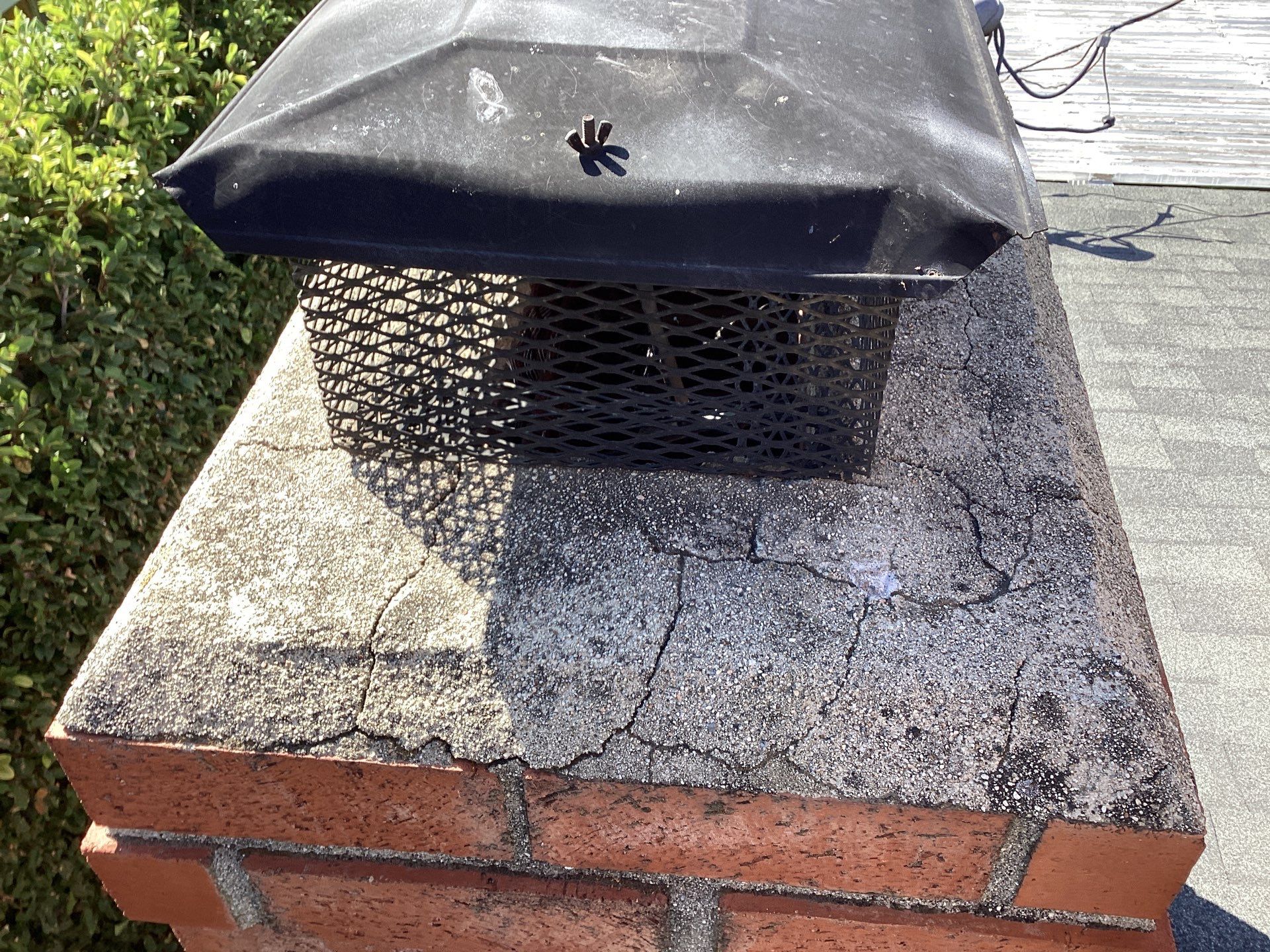 Chimney cap with brick and moss-covered surface