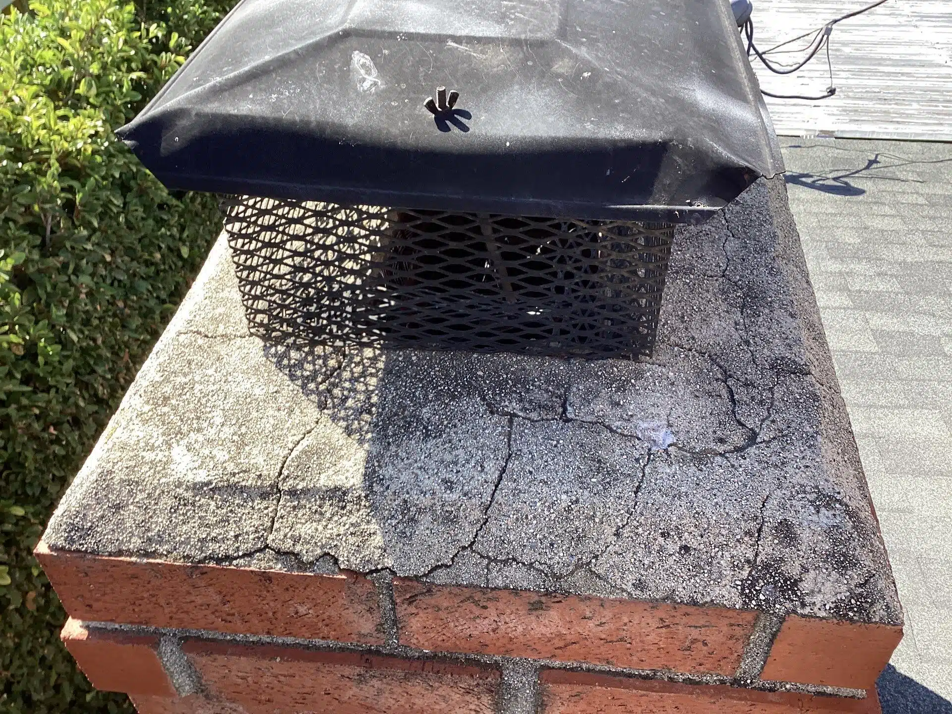 Chimney cap with brick and moss-covered surface