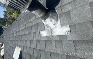 Roof with vent and gray shingles.
