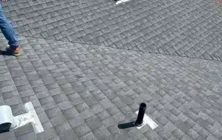 18-Oct 02 2025 01_35pm-xqTu View of shingled roof with vent pipes and trees.