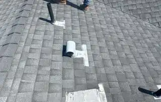 Person inspecting rooftop shingles under sunlight.