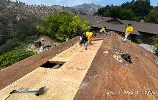 2-Sep 11 2025 01_26pm-3fAQ Roofers working on wooden roof repair project.