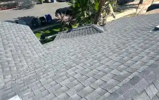 View of shingled rooftop and street below