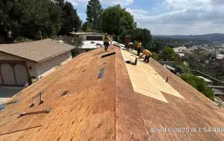 3-Sep 11 2025 01_54pm-ScZK Roofers working on wooden roof structure repair.