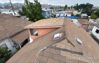 View of neighborhood rooftops and landscape.
