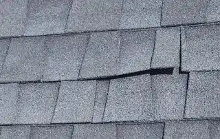44-Oct 02 2025 04_32pm-XSPS Gray asphalt roof shingles with slight damage.