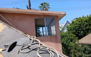 Rope on a sloped roof, blue sky background.