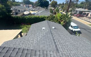 View of residential rooftops and backyard garden.