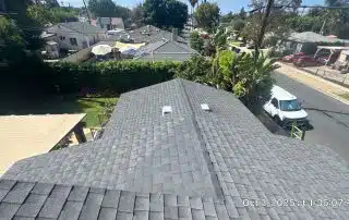 View of residential rooftops and backyard garden.