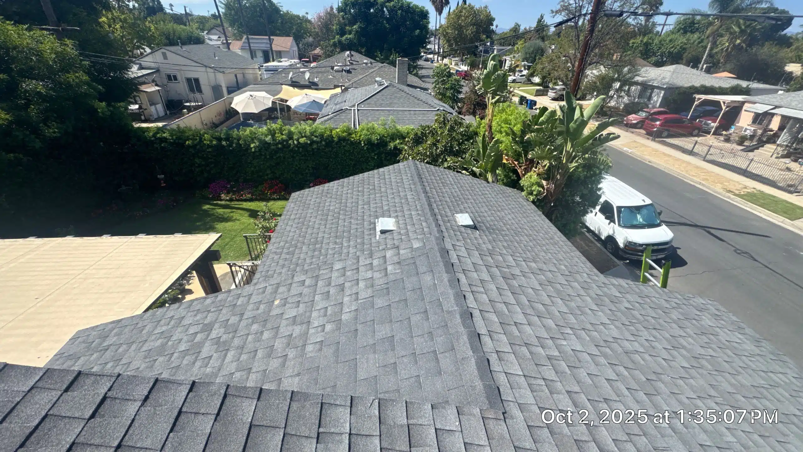 View of residential rooftops and backyard garden.