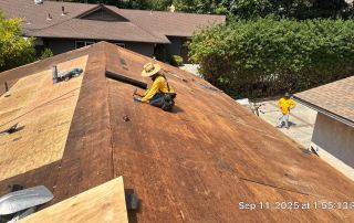 5-Sep 11 2025 01_55pm-Q8im Workers roofing house with plywood panels.