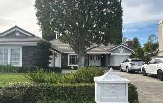 Suburban house with mailbox and parked cars