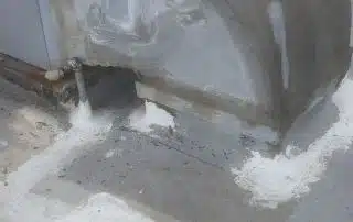Rooftop HVAC duct sealant application close-up view.
