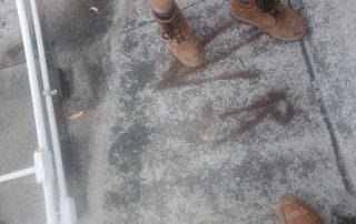 10-Dec 25 2025 01_08pm-Z3R3 Person in work boots standing on rooftop surface.