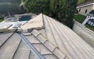 Roof with shingles overlooking pool and greenery.