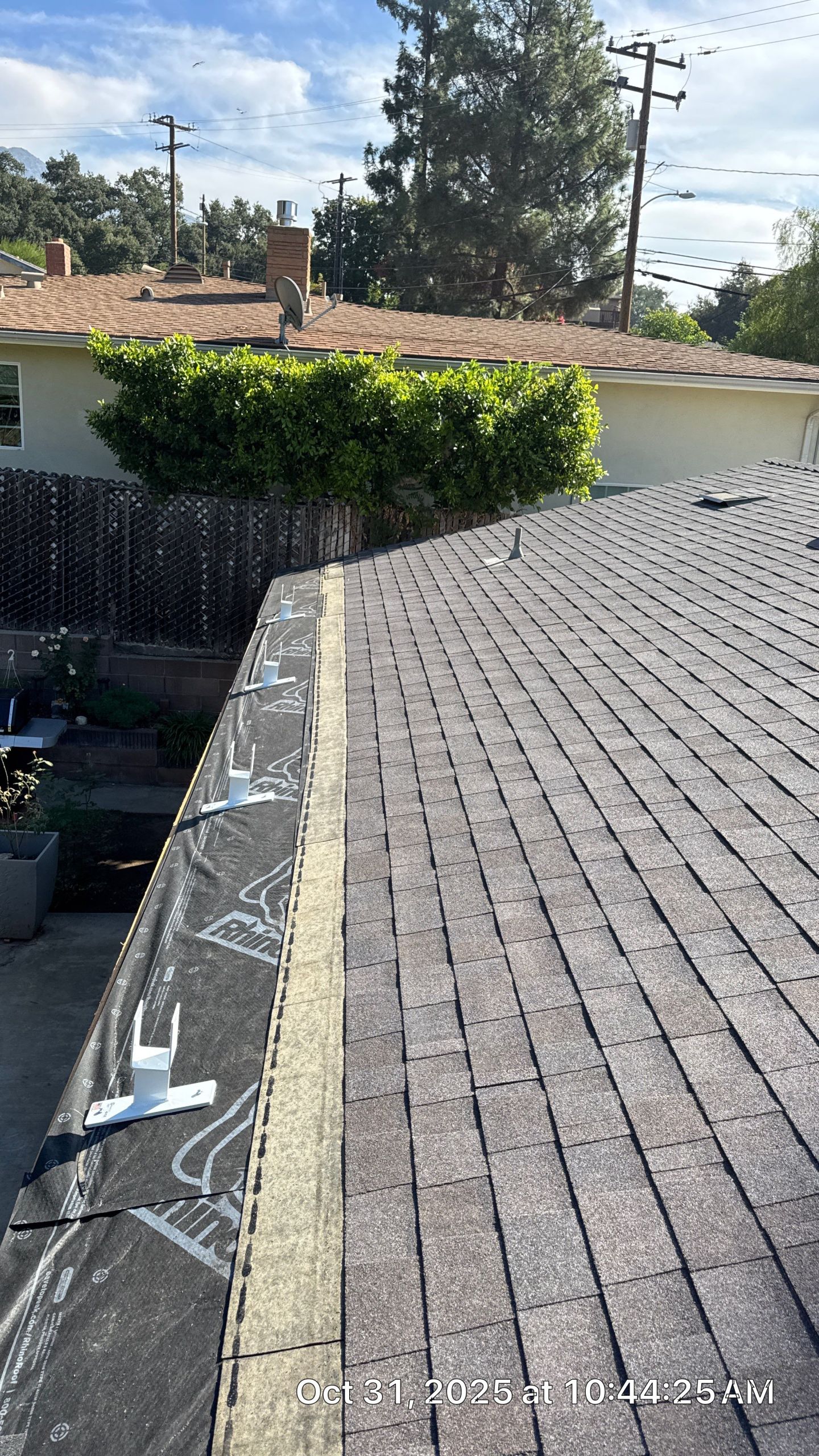 Rooftop view showing roof shingles installation.