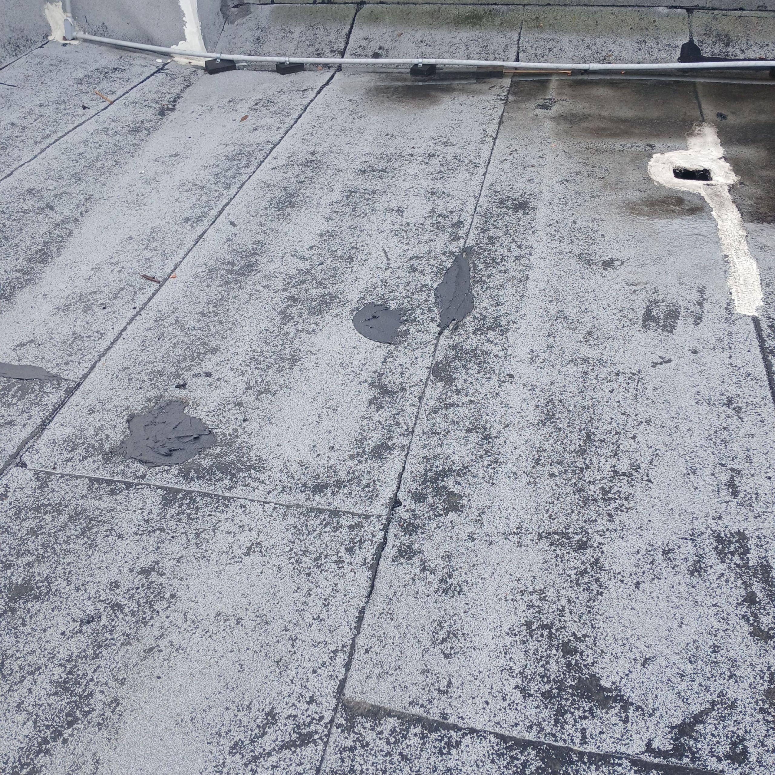 14-Feb 17 2026 09_36am-61qp Flat roof with patched areas.
